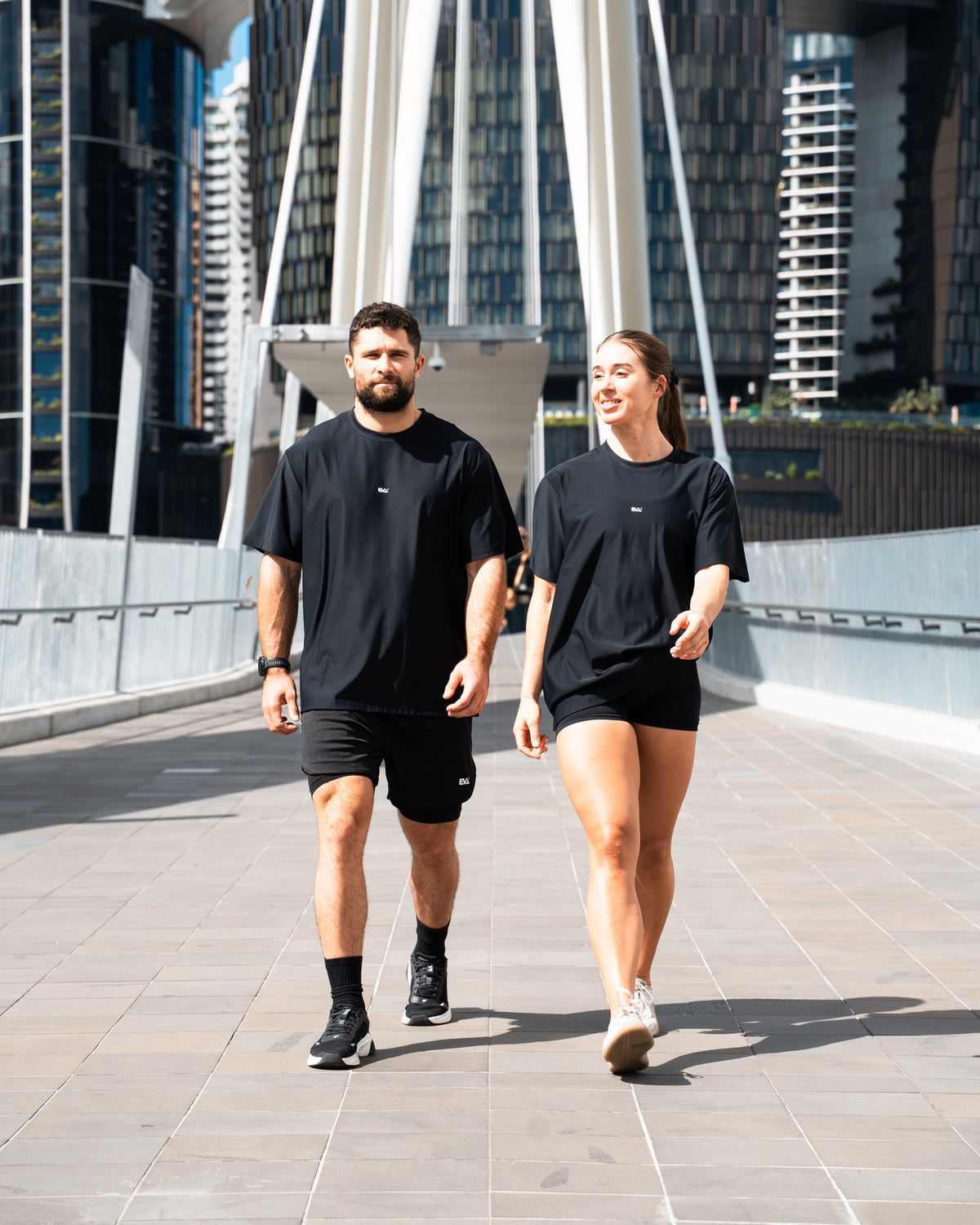 Legacy Oversize Tee in Black - worn by two models walking in the city