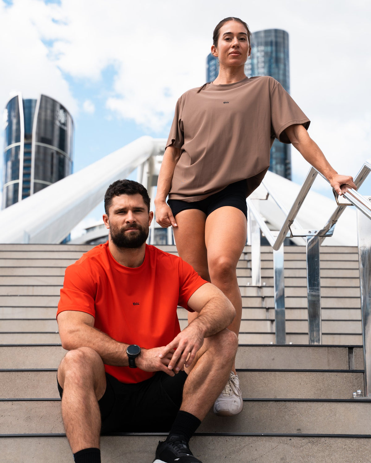 Legacy Oversize Tee in Clay Brown - female model on city steps