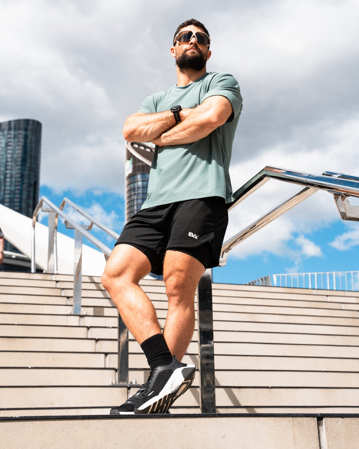 Legacy Oversize Tee in Dusty Teal - male model on city stairs